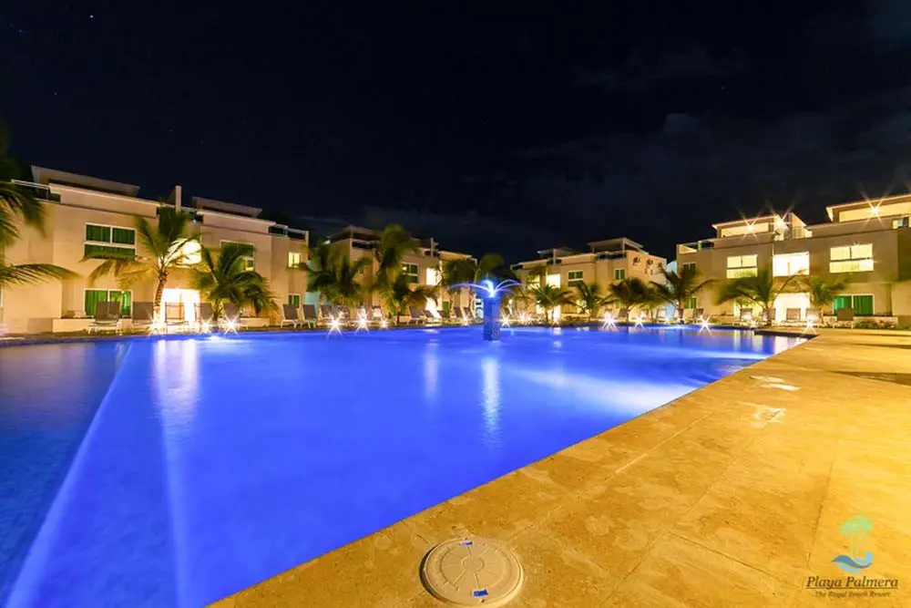 Illuminated pool at night at Beach Apartamentos in Playa Palmera